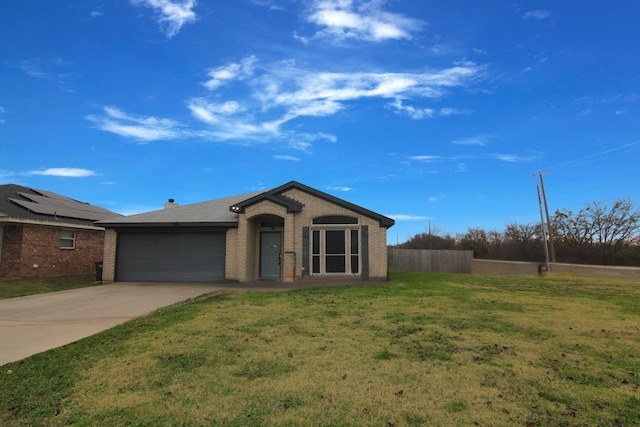 single story home featuring a front lawn and a garage