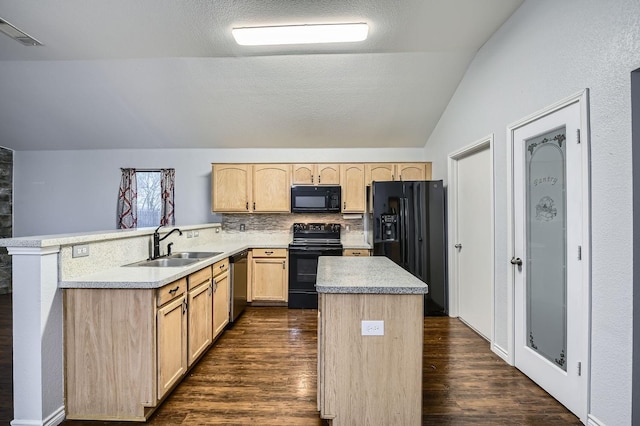 kitchen featuring sink, dark wood-type flooring, black appliances, light brown cabinetry, and vaulted ceiling