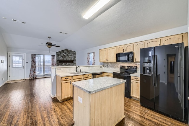 kitchen with sink, vaulted ceiling, light brown cabinets, kitchen peninsula, and black appliances