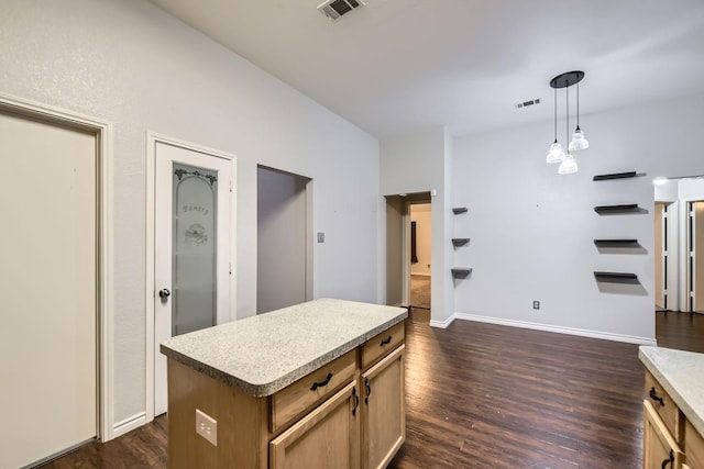 kitchen with pendant lighting, dark wood-type flooring, and a center island