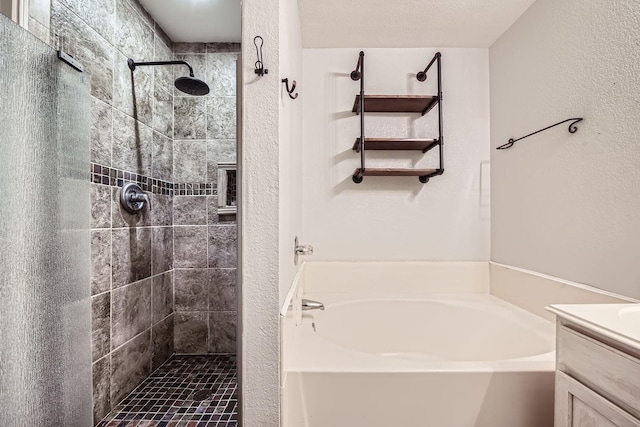 bathroom with vanity, plus walk in shower, and a textured ceiling