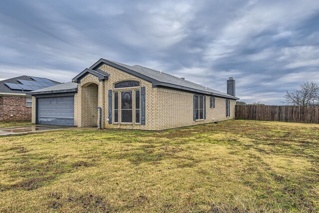 single story home with a front lawn and a garage