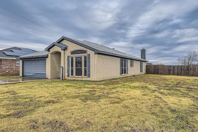 view of front of house featuring a garage and a front lawn