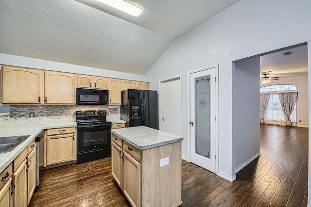 kitchen featuring lofted ceiling, dark wood-type flooring, light brown cabinets, and black appliances