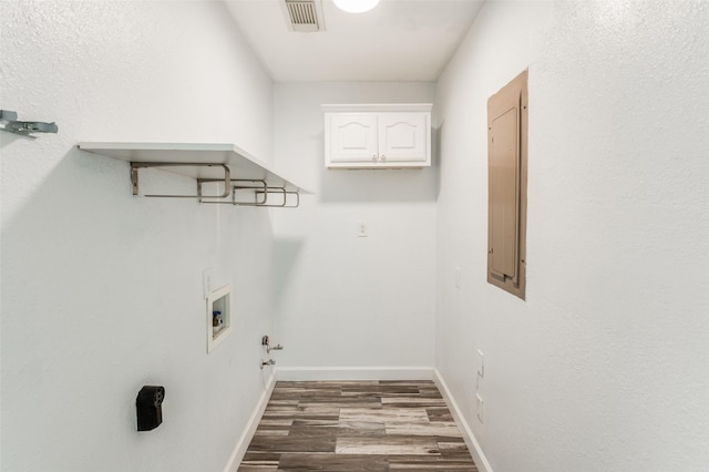 washroom with hardwood / wood-style floors, electric panel, and hookup for a washing machine