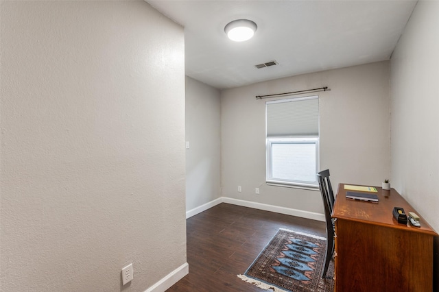 unfurnished office with dark wood-type flooring