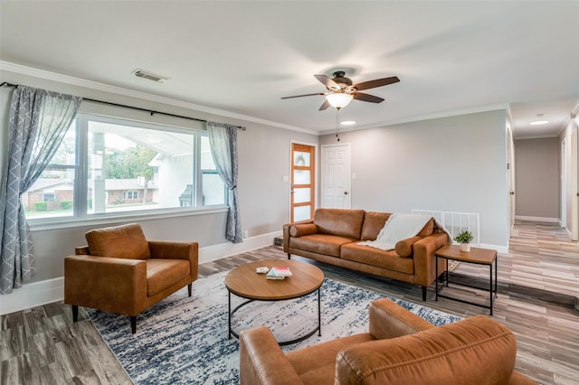 living room featuring crown molding, ceiling fan with notable chandelier, and dark hardwood / wood-style flooring