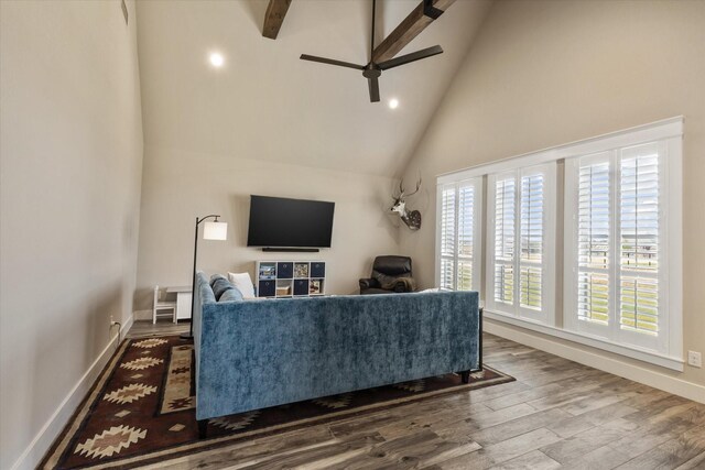 living room featuring ceiling fan, hardwood / wood-style floors, and high vaulted ceiling