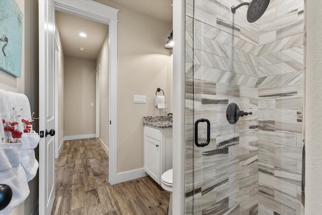 bathroom with vanity, hardwood / wood-style floors, an enclosed shower, and toilet