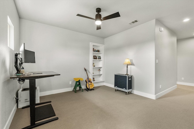 workout area featuring carpet floors and ceiling fan