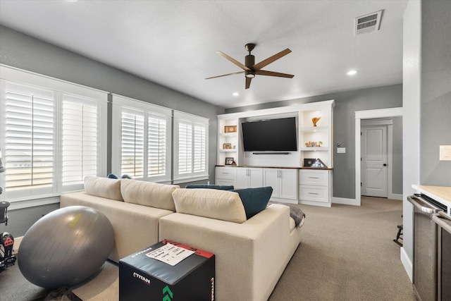 living room featuring light colored carpet and ceiling fan