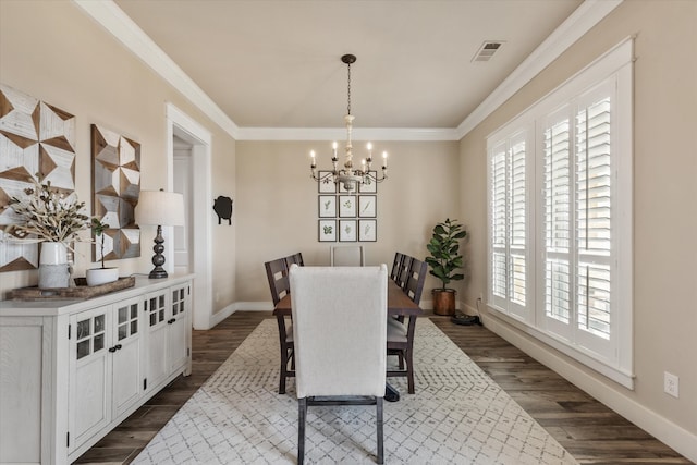 dining area featuring crown molding, dark wood-type flooring, and a notable chandelier