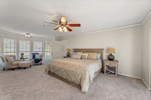 bedroom featuring crown molding, ceiling fan, and light carpet