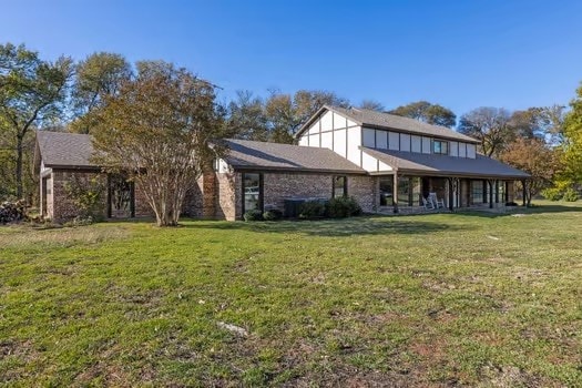 rear view of house featuring a lawn