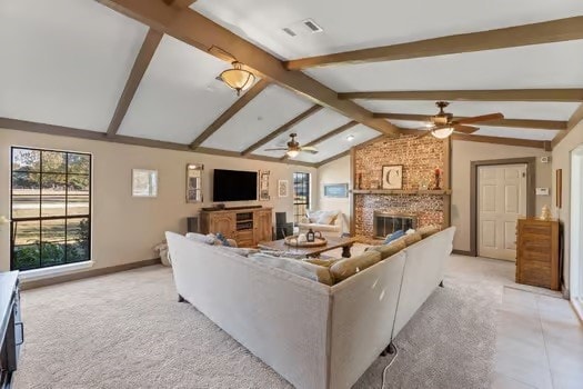 living room with lofted ceiling with beams, ceiling fan, light carpet, and a fireplace