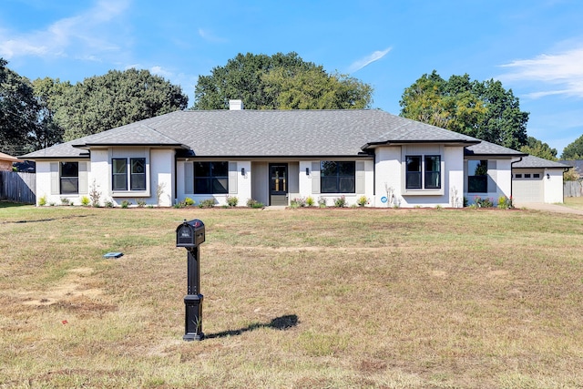 view of front of house with a garage and a front yard