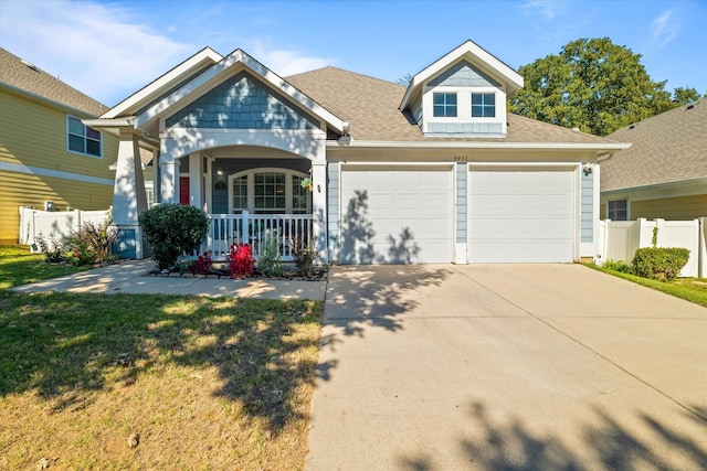 craftsman inspired home featuring a garage and covered porch