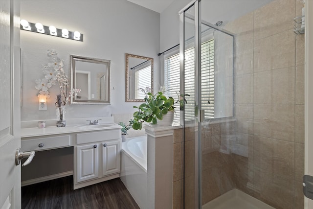 bathroom featuring vanity, plus walk in shower, and wood-type flooring