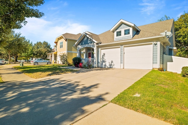 view of front of property with a garage and a front yard