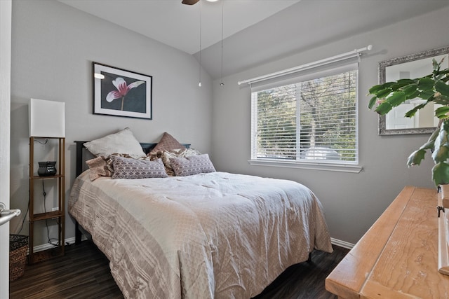 bedroom with ceiling fan, dark wood-type flooring, and lofted ceiling