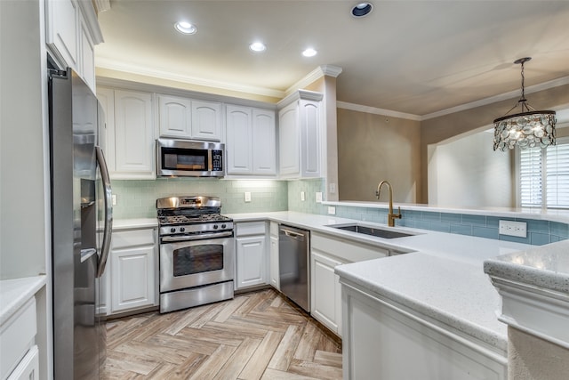 kitchen featuring appliances with stainless steel finishes, sink, a notable chandelier, light parquet flooring, and white cabinetry