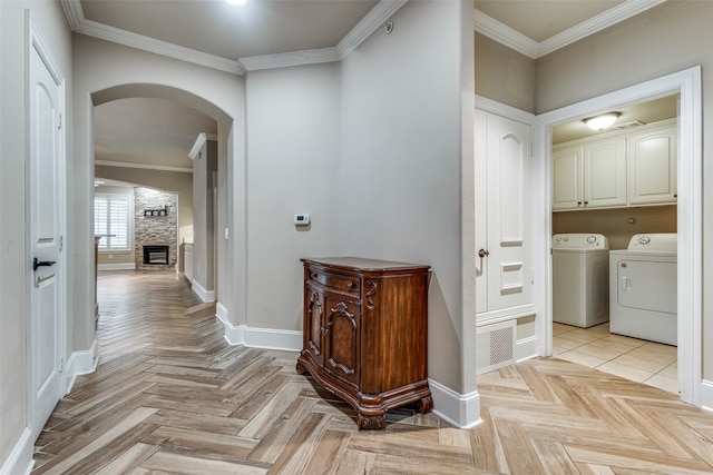 corridor featuring washer and dryer, light parquet flooring, and crown molding