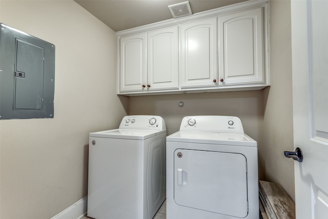 laundry room featuring electric panel, cabinets, and washing machine and dryer