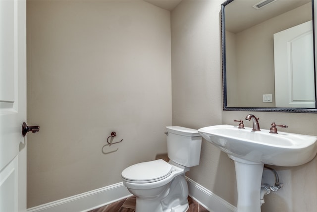 bathroom featuring toilet and hardwood / wood-style flooring