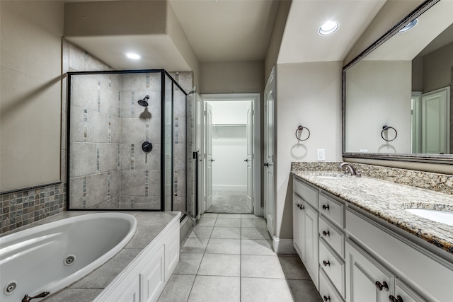 bathroom with plus walk in shower, tile patterned flooring, and vanity