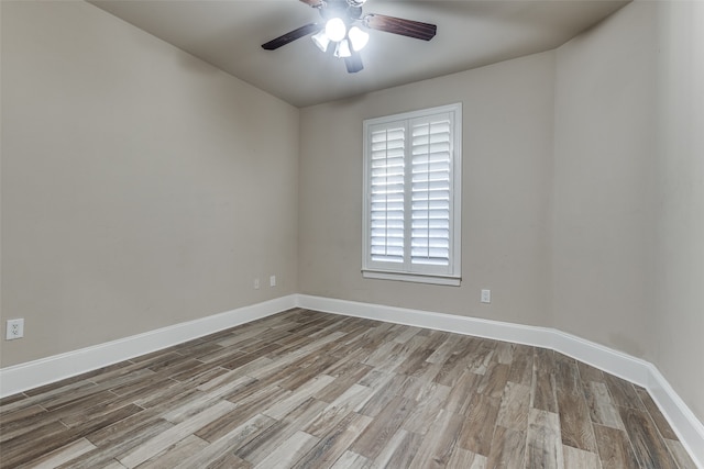 empty room with ceiling fan and light hardwood / wood-style flooring