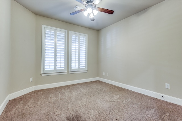 empty room featuring ceiling fan and carpet floors