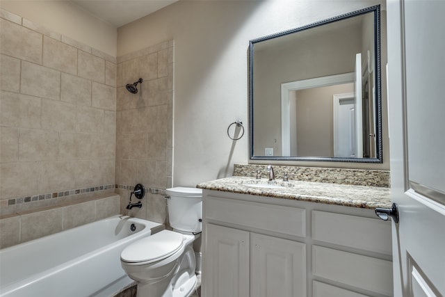 full bathroom with vanity, toilet, and tiled shower / bath