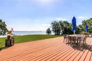 wooden terrace featuring a yard and a water view