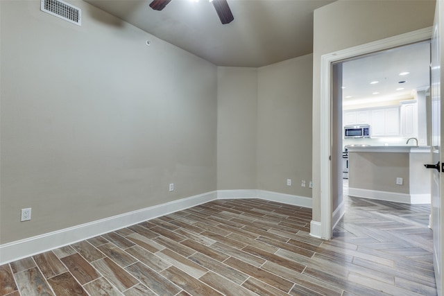 empty room featuring ceiling fan and light wood-type flooring