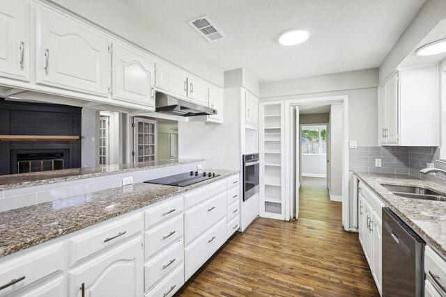 kitchen with white cabinetry, sink, stainless steel appliances, tasteful backsplash, and dark hardwood / wood-style flooring