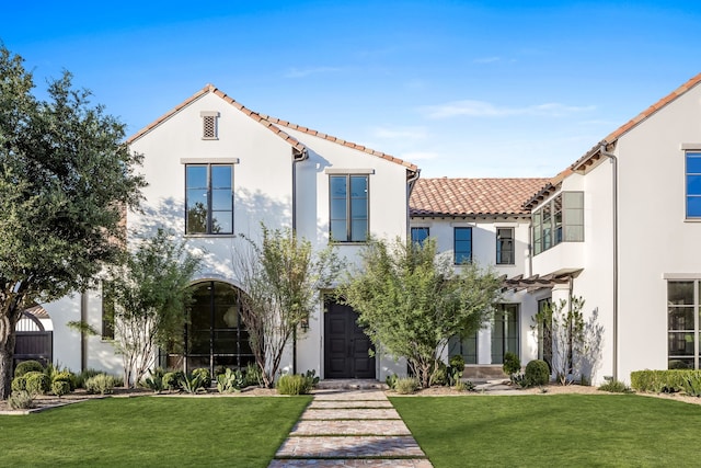 mediterranean / spanish-style house with a front lawn