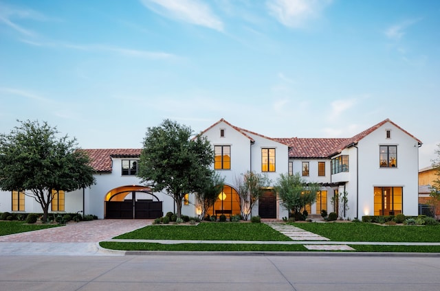 mediterranean / spanish house featuring a front yard