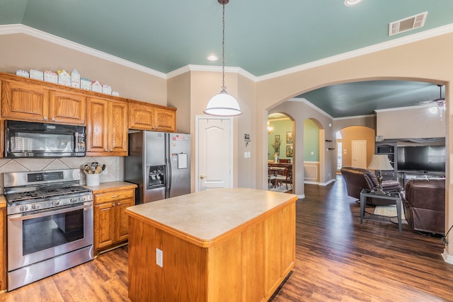 kitchen with a center island, tasteful backsplash, dark hardwood / wood-style flooring, decorative light fixtures, and appliances with stainless steel finishes