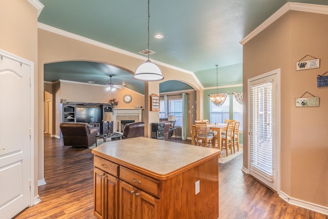 kitchen featuring decorative light fixtures, a center island, dark hardwood / wood-style floors, and ceiling fan with notable chandelier