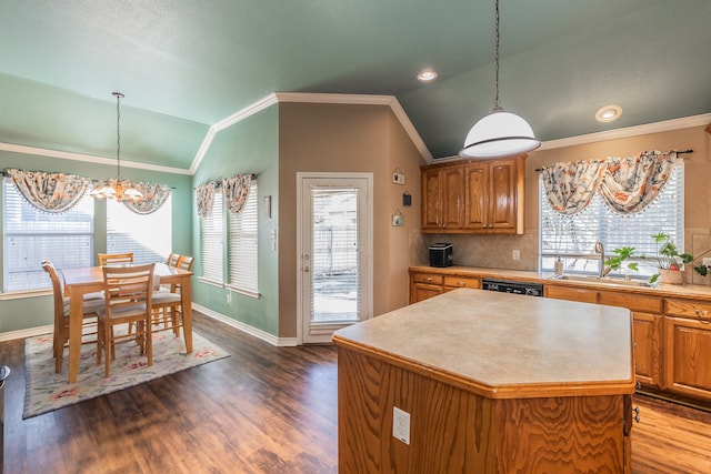 kitchen featuring sink, dark wood-type flooring, a notable chandelier, vaulted ceiling, and a kitchen island