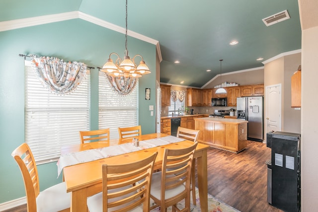 dining room with dark hardwood / wood-style floors, lofted ceiling, ornamental molding, and an inviting chandelier