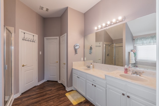 bathroom with plus walk in shower, vanity, and hardwood / wood-style flooring