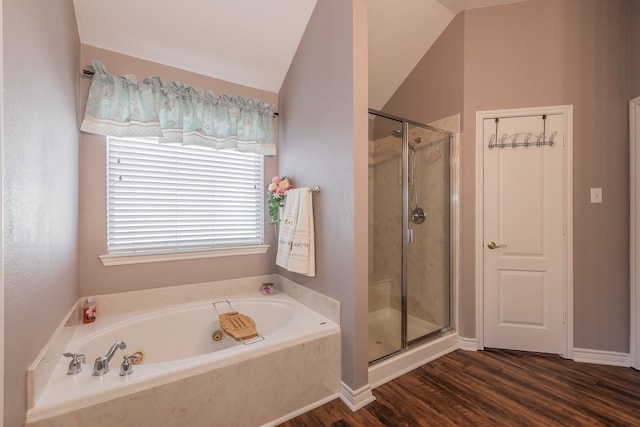 bathroom with independent shower and bath, vaulted ceiling, and hardwood / wood-style flooring