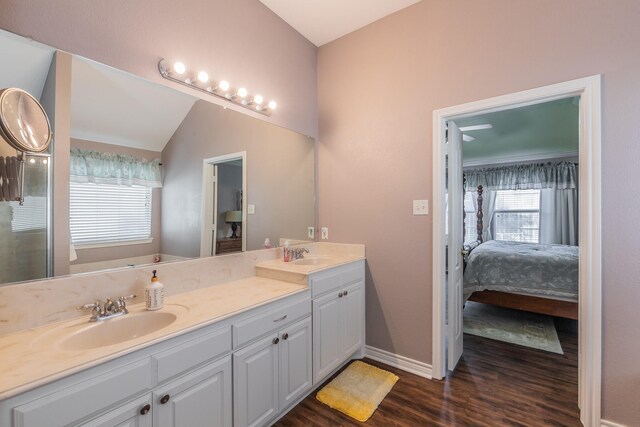 bathroom with vanity, wood-type flooring, and lofted ceiling