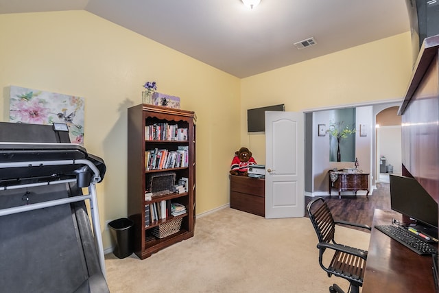 carpeted office with vaulted ceiling