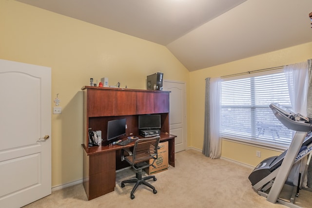 office space featuring light carpet and vaulted ceiling