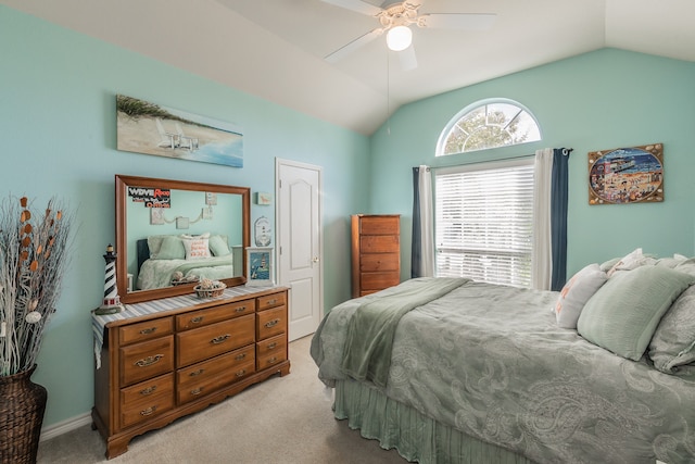 bedroom featuring ceiling fan, light carpet, and vaulted ceiling