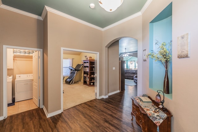 hall featuring hardwood / wood-style floors, crown molding, and washing machine and clothes dryer