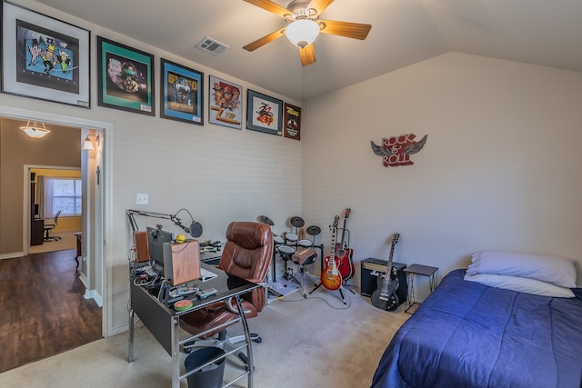 bedroom with ceiling fan, wood-type flooring, and vaulted ceiling