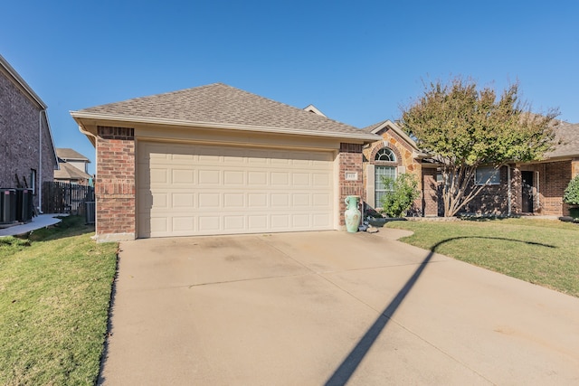 ranch-style home featuring a front lawn and a garage